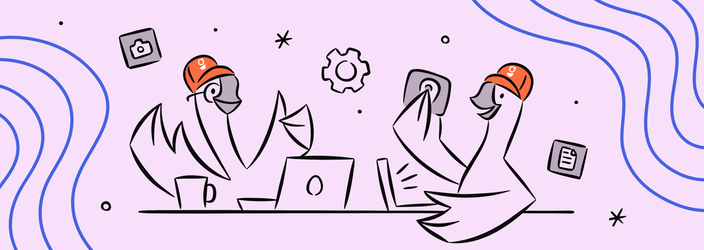 two illustrated geese working on laptops