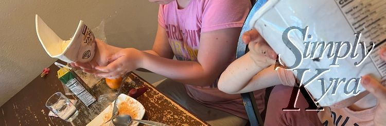 Girls "cleaning" out the empty container.