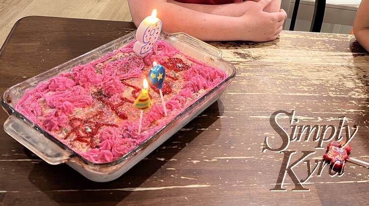 Another view of the now candle decorated cake about to be cut and served.