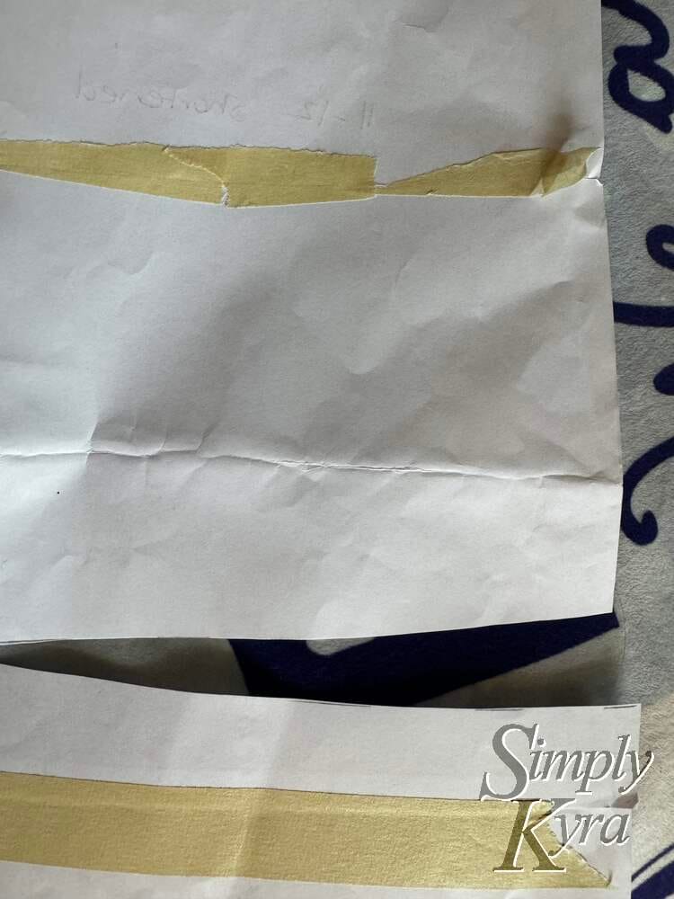 The old crinkled pattern has been tapped up (near the top) and cut again lower down. The bottom tape shows where I tapped the original paper pattern together. 