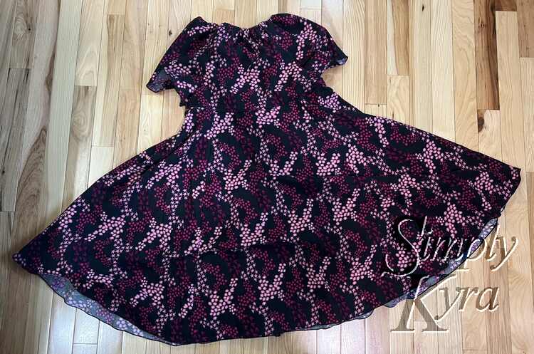 Image shows a flat lay of the front of the dress. 