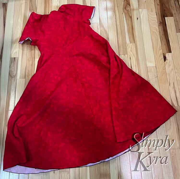 Image shows a flat lay of the front of the dress with the side tucked in to fit in the photo. 