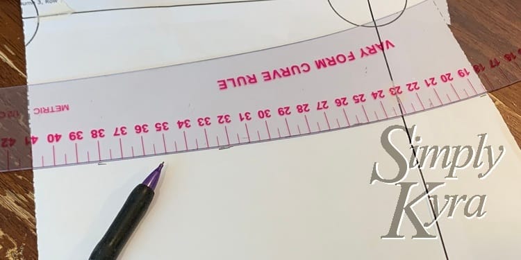 After measuring from the bottom and marking I use a French ruler to check the curve and draw a line. 