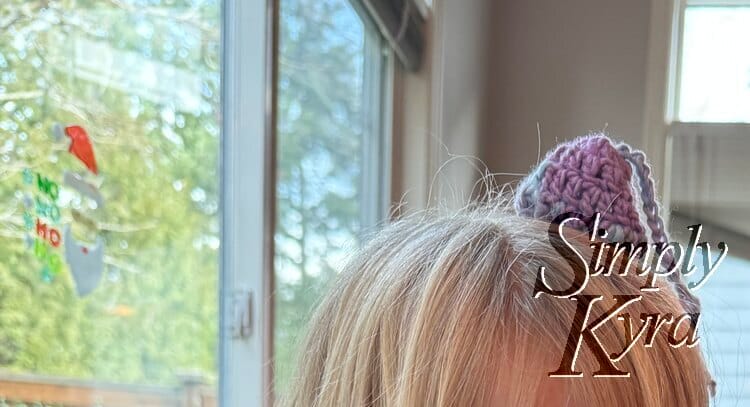 The hat with the single strand of hair attached sit precariously on Zoey's blonde head.