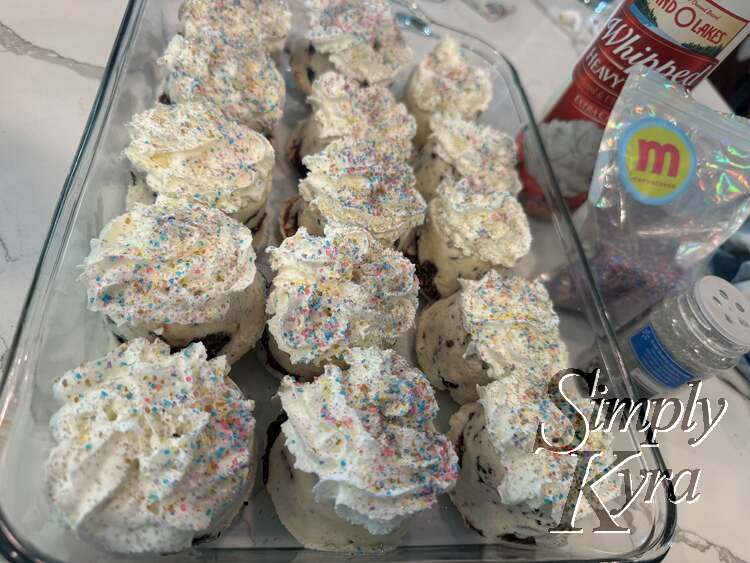 The glass casserole dish is now filled with 5 by 3 whipped cream and sprinkled ice cream cupcakes.
