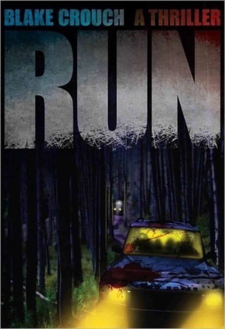 A blood splattered car with headlights in the foreground, semi in the background, and trees all around!