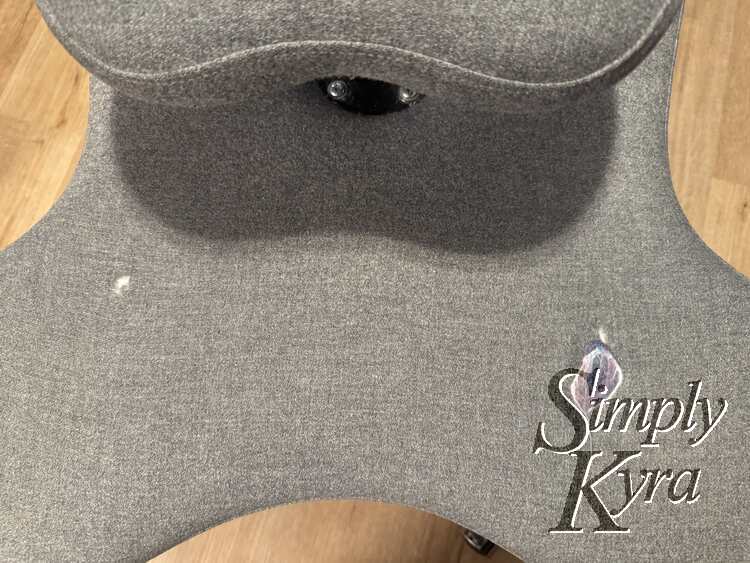 Image shows the hole and smudged patchwork on the chair. 