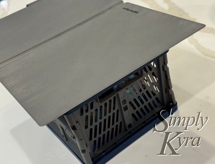 Image shows the reMarkable cover opened flat laid out over a holey bin. 