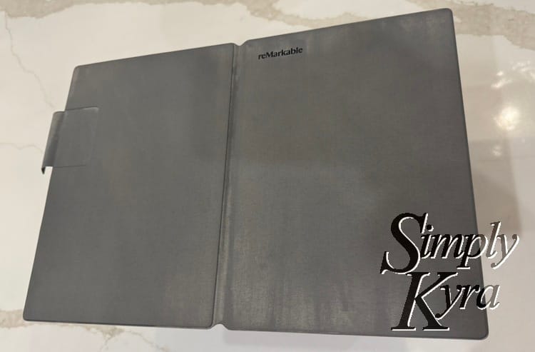 Image shows the reMarkable cover opened flat with the back and front facing up showing the streaks. 