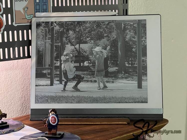 The reMarkable 2 on its side on my desk showing my kids on swings.