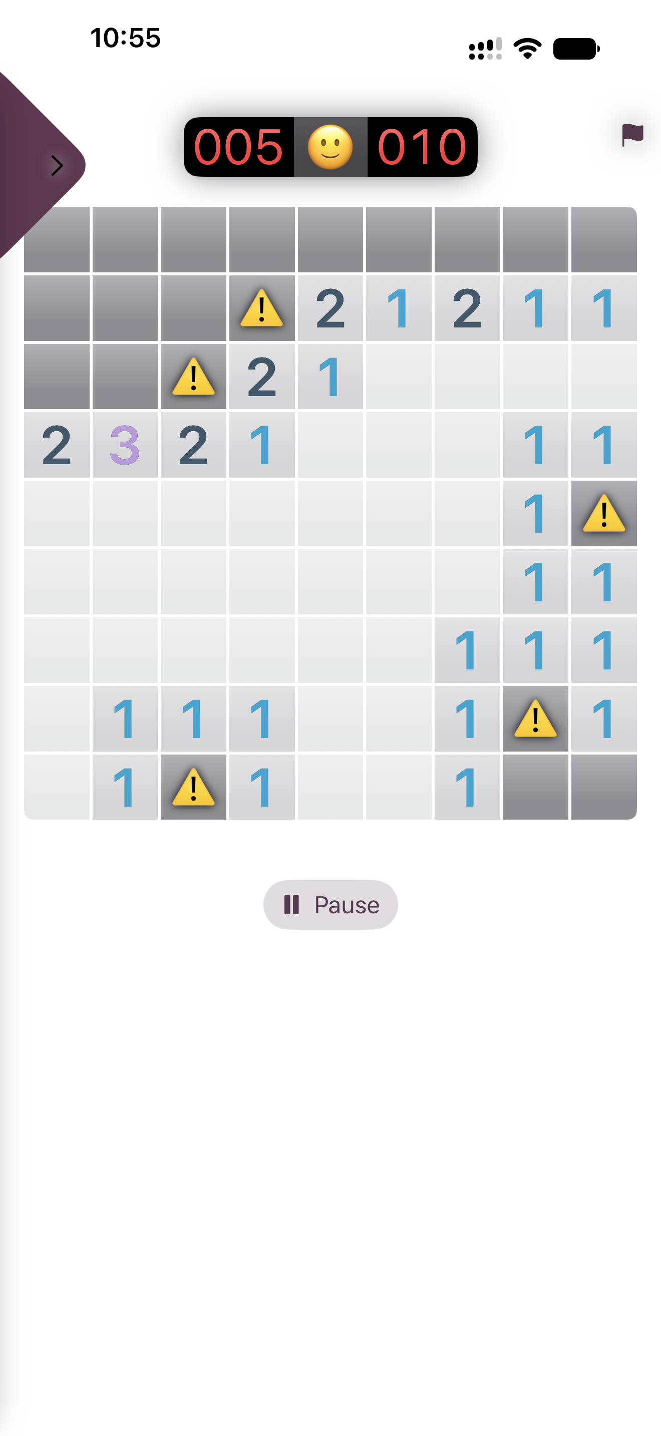 iPhone screen showing a Minesweeper-style board mid-game in light mode, with revealed numbers in purple and blue, a few squares marked with warning-triangle icons, and a counter showing 5 flagged and 10 total mines.