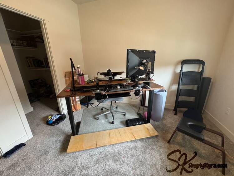 Image shows a desk angled in a room with equipment around it.