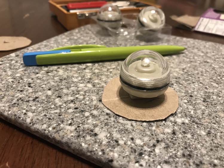 Line up the light on the center of you cardboard circle and mark where the hook is.