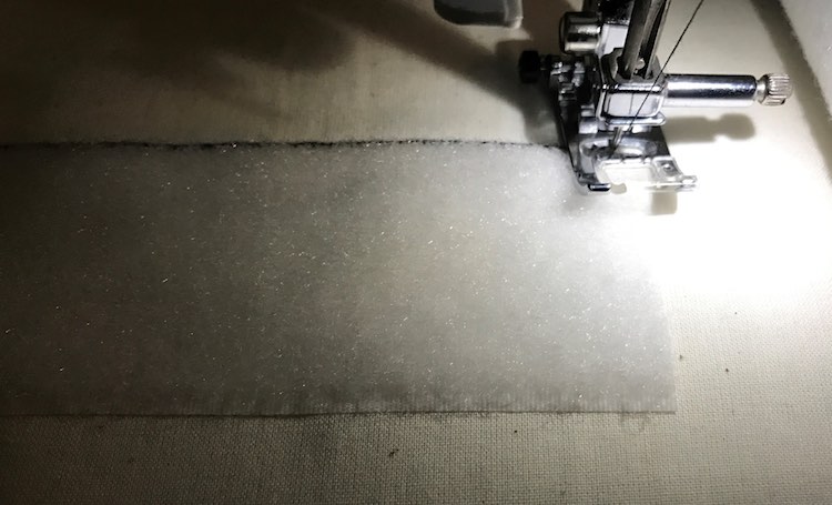 Closeup of sewing the loop Velcro onto the book cover.