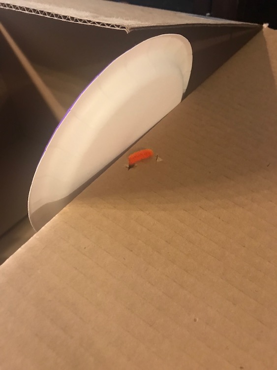 I ended up poking a couple holes in the box flap to secure the wheel.