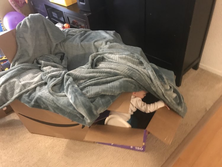 Create a 'tent' by draping a blanket over the box and maybe play peek-a-boo.