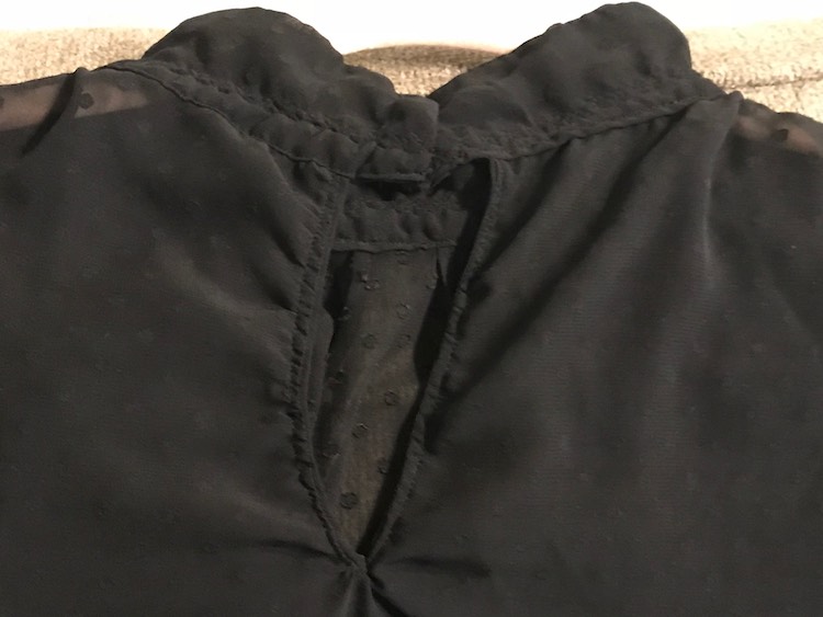 Keyhole detail on the back of the blouse.