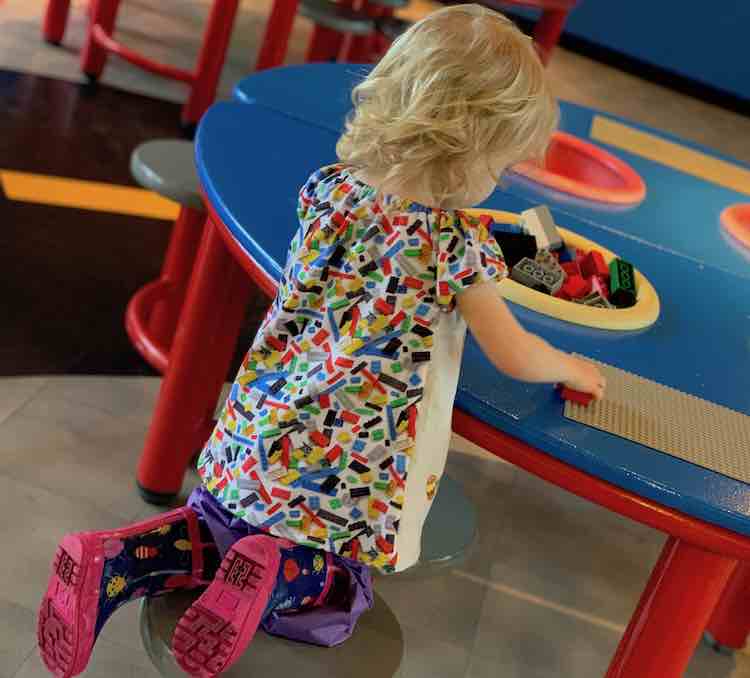 Zoey playing with DUPLO®.