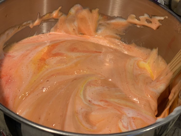 Same bowl but now mostly orange with swirls of yellow and orange. Less bubbles.