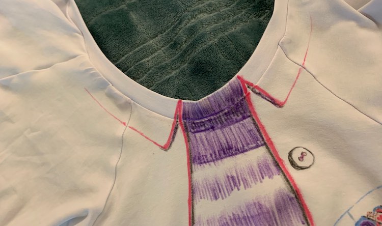 Front of the shirt with neckband on. The under shirt and collar have been drawn into the neckband and the collar continues and inch or two into the sleeves.