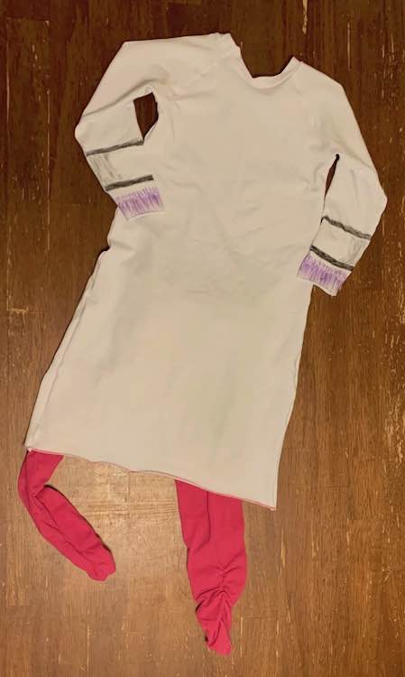 Back of the Doc McStuffins outfit. You can only see the coloring on the sleeves. Pink pants are sticking out below the coat.