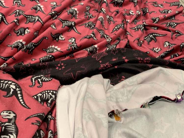 Image shows both types of fabrics but at the bottom right you see the backside of both fabric and they're clipped together right sides together. 