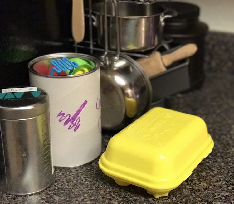 Almost the same items as the above image although this one includes a closed plastic egg set. View is angled from the front with the back items slightly blurry.