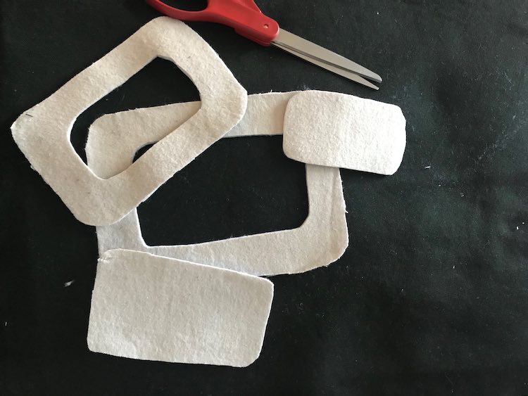 The four rectangles that were cut out are shown here. At the bottom is the large rectangular outline while overlapping it at the top is the smaller one. The smallest, solid, rectangle is to the right and the larger one is at the bottom. Above it all are my scissors. 