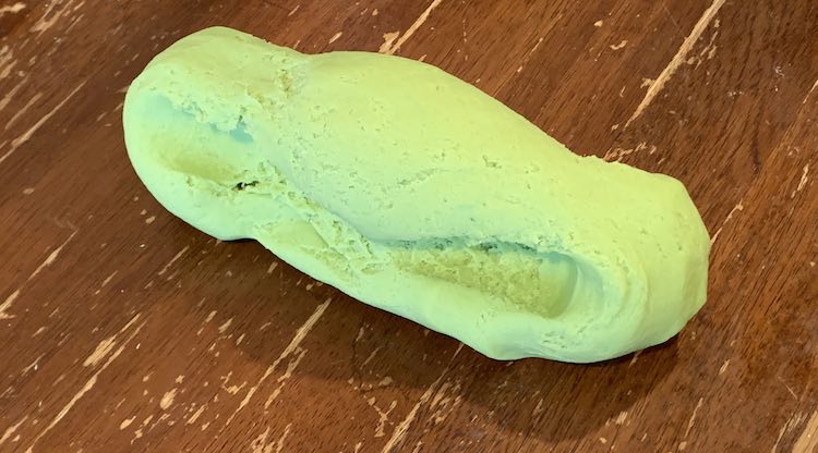 The playdough is now a shorter, than the above, cylinder. You can see the grooves in the side where I held the playdough as I pulled. The width, along it's length, is similar all the way so it doesn't show any parts that were about to crumble if I pulled for longer.