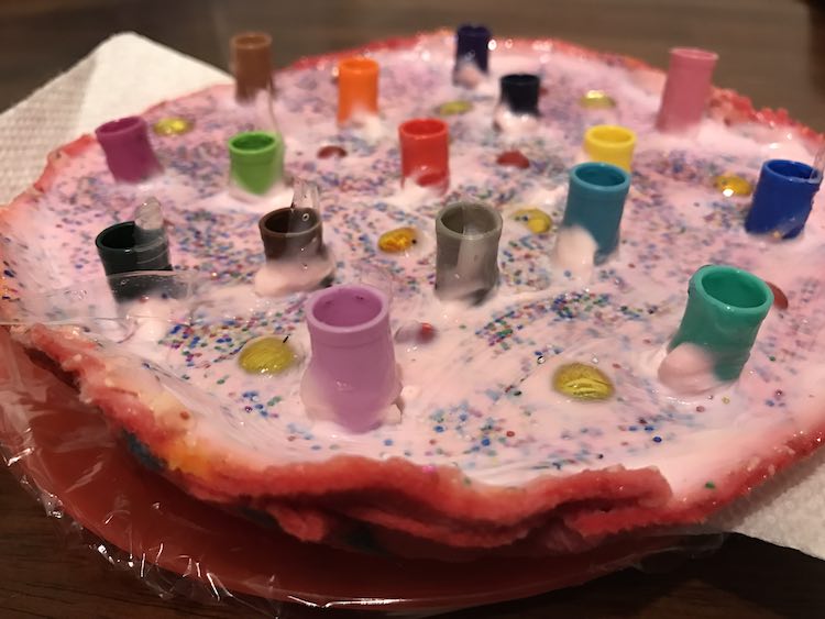 Closeup of the base without the markers in the lids. You can see the pink hued plaster of paris and mod podge with the multi colored glitter and plastic gemstones showing through the clear mod podge.