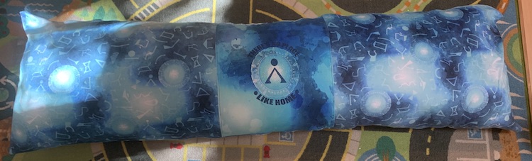 Closeup of the long Stargate pillow. The light from the window is shining on the left side causing the one stargate to light up more compared to the others.