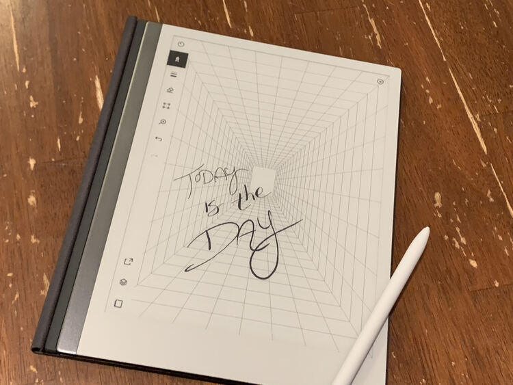 Image shows my reMarkable2 with the words "Today is the Day" scrawled out in three different pen types. Behind it are lines reaching out to the center back of the page.