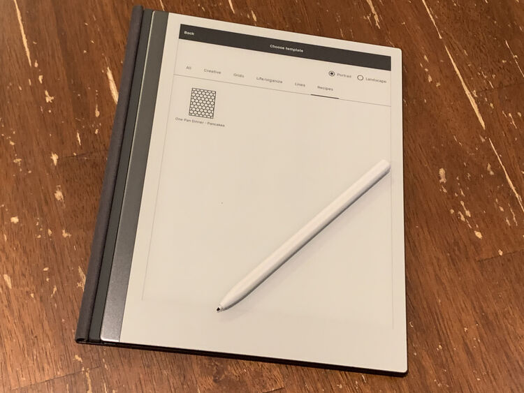 Image shows my reMarkable open on the table with the folio folded back and the pen resting on top of it. The reMarkable is on and showing the contents of the newly created Recipes category as I switch out the template for a notebook page.