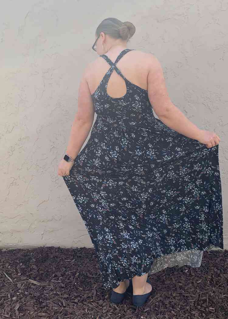 Image shows the back of the lightweight cotton spandex blend Brazi dress as spread the skirt out.