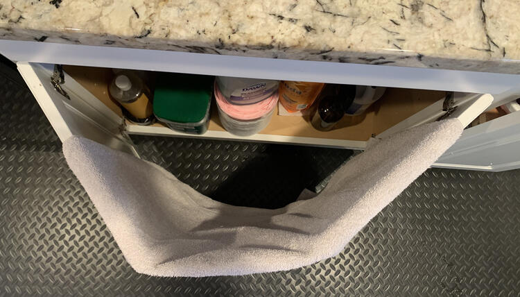 Again the image is taken from above although now the towel is draped over either cupboard door.