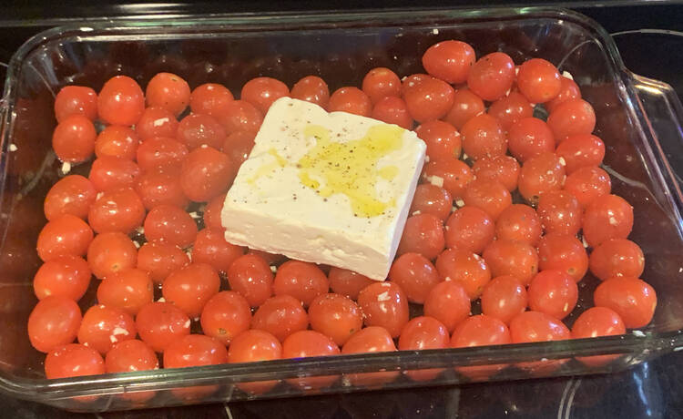 The cherries laid out in the pan with the toppings on top.