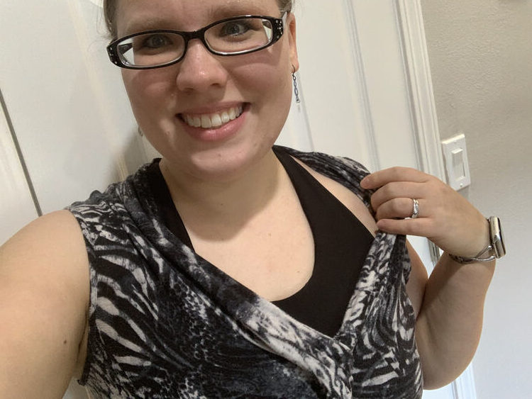 Image shows more of the black Brazi as it's worn under the same top as the previous set of photos. Here the straps are closer to my neckline and I'm pulling the neckline of the shirt overtop away to show more of the Brazi.