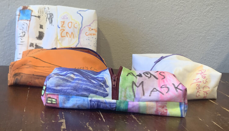 Image shows four colorful zippered pouches laid out on a table.