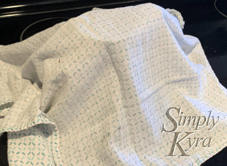 Image shows a light tea towel in a mountain shape as it covers the jars in the previous photo.