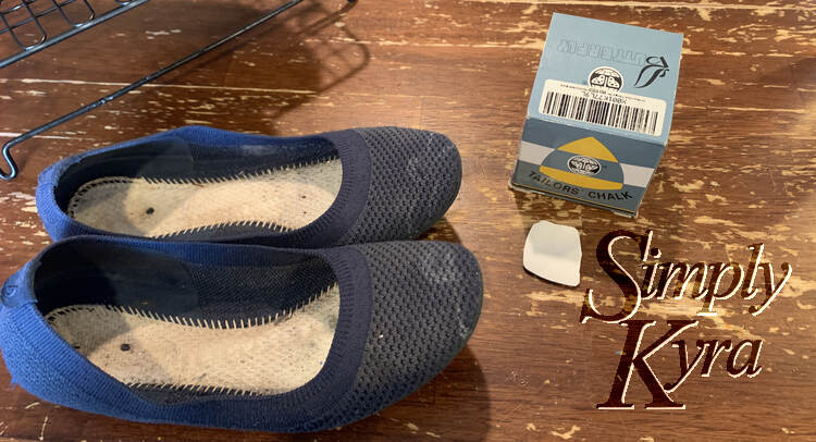 Image shows the pair of flats side by side with an outline of a flower sketched on either. The cooling rack, flat tailor's chalk, and box of chalks rest beside it.