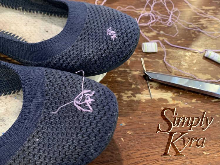 Image shows the shoe tip with the back flat only patched and the front flat with a vague outline and two threads extending after it was knotted but not trimmed.