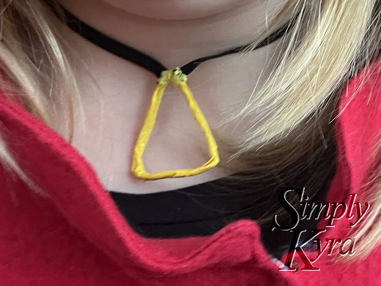 Image shows a closeup of Ada's neck while wearing her costume and the necklace.