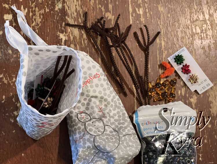 Image shows the bags with one on its side and the other upright to show what's inside it. Off to the side are more supplies. 