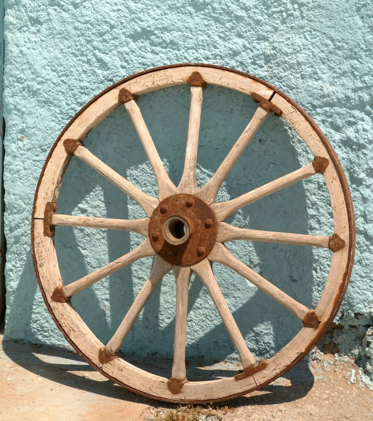 Old rusty bullock cart wheel, weathered and cracked, symbolizing Carl Jung’s idea of ancient cycles, the collective unconscious, and timeless symbols