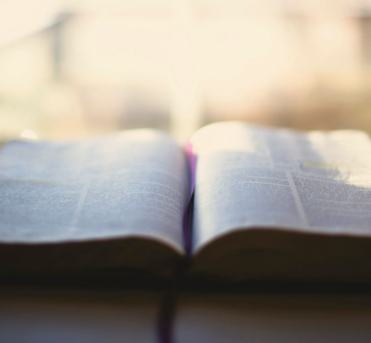 An open book resembling ancient scripture, symbolizing divine law beyond religion.