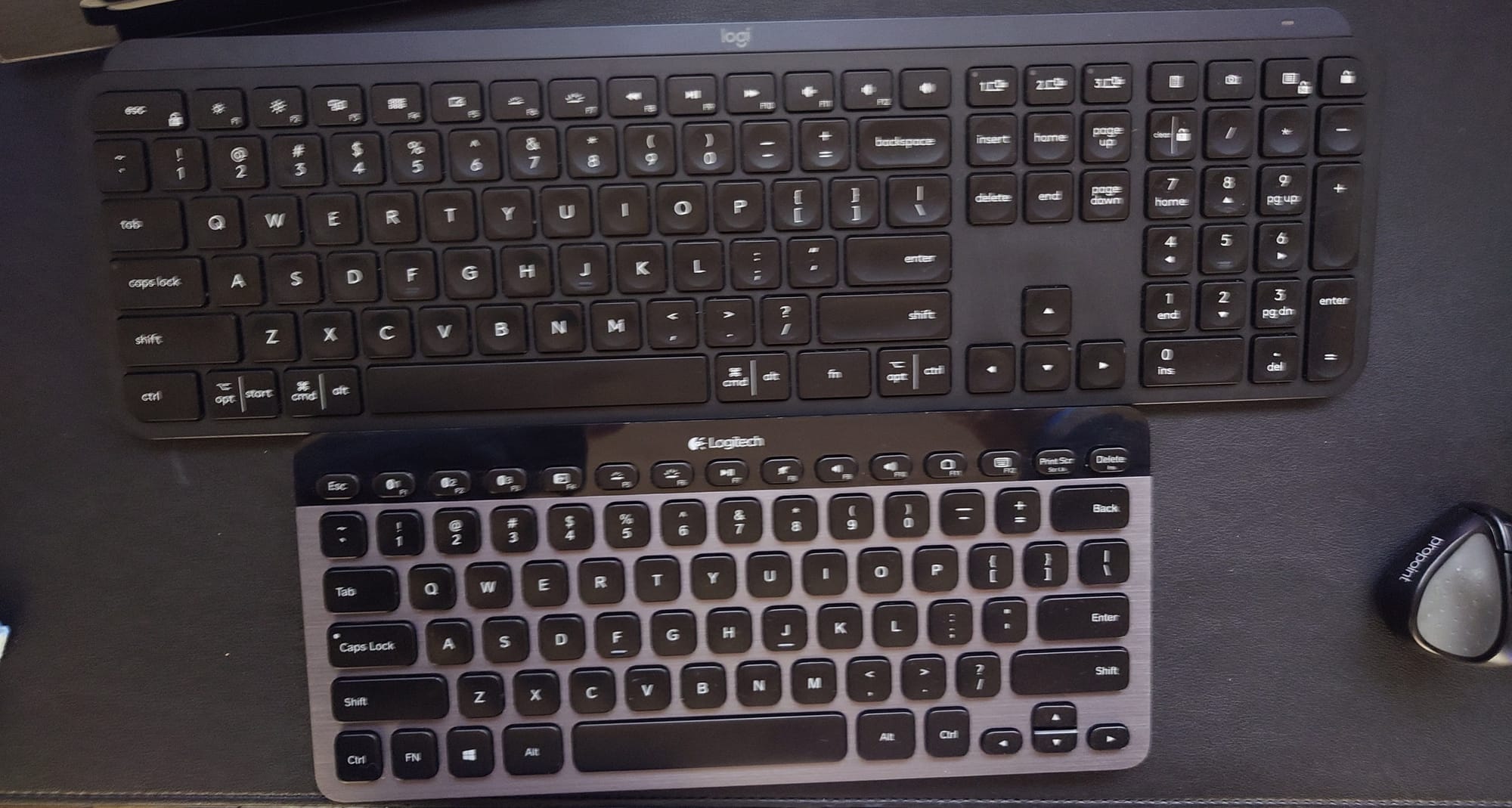 the Logitech MX Keys is now shown along with the Logitech K810, a smaller BT keyboard with no number row.  The MX Keys is solid black and the K810 has a black strip along the top behind the function keys and the rest is a steel gray color. 