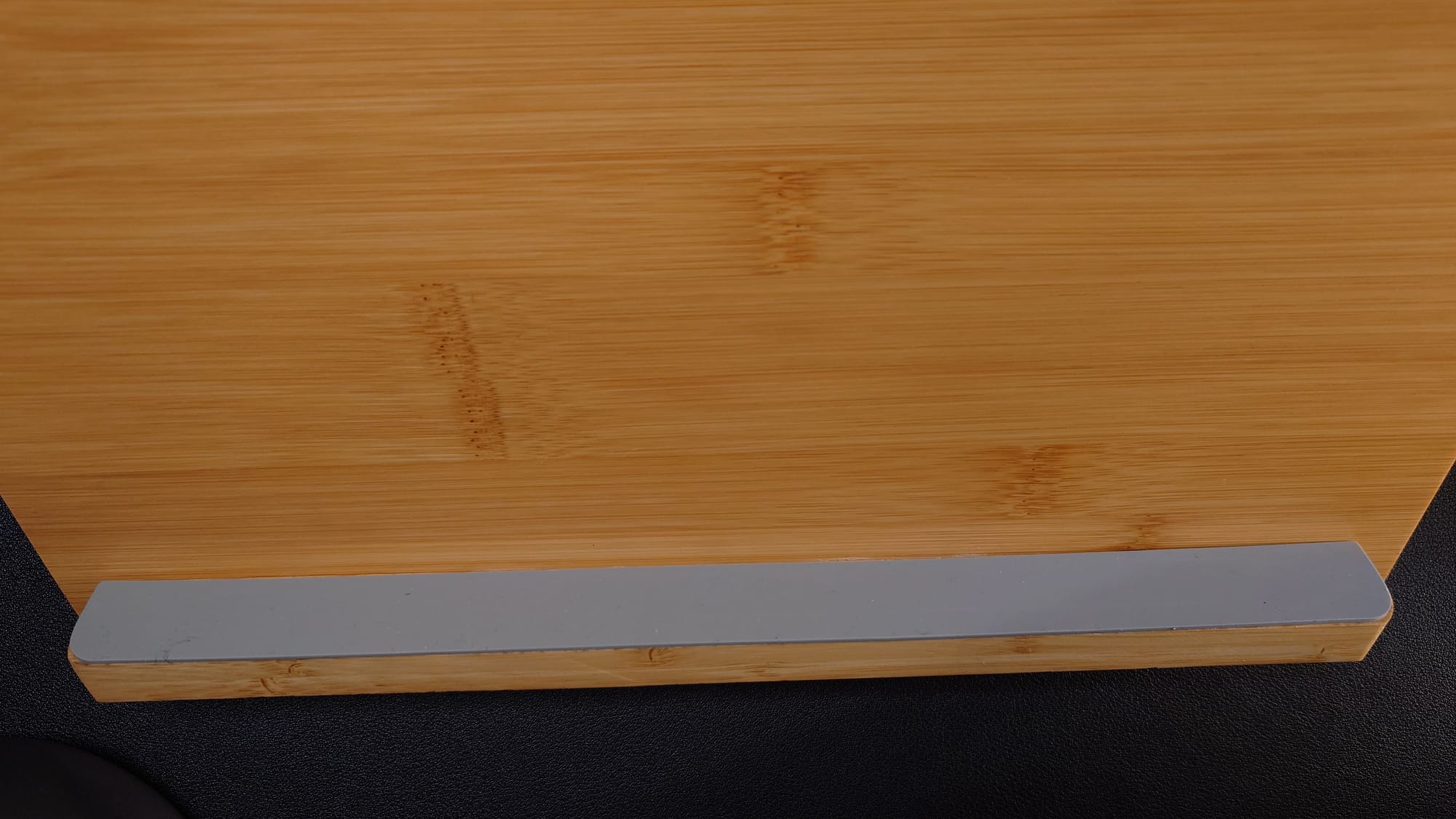 The rubbery base for the tablet to sit on is gray.  It allows for extra grip to keep the tablet on the stand.