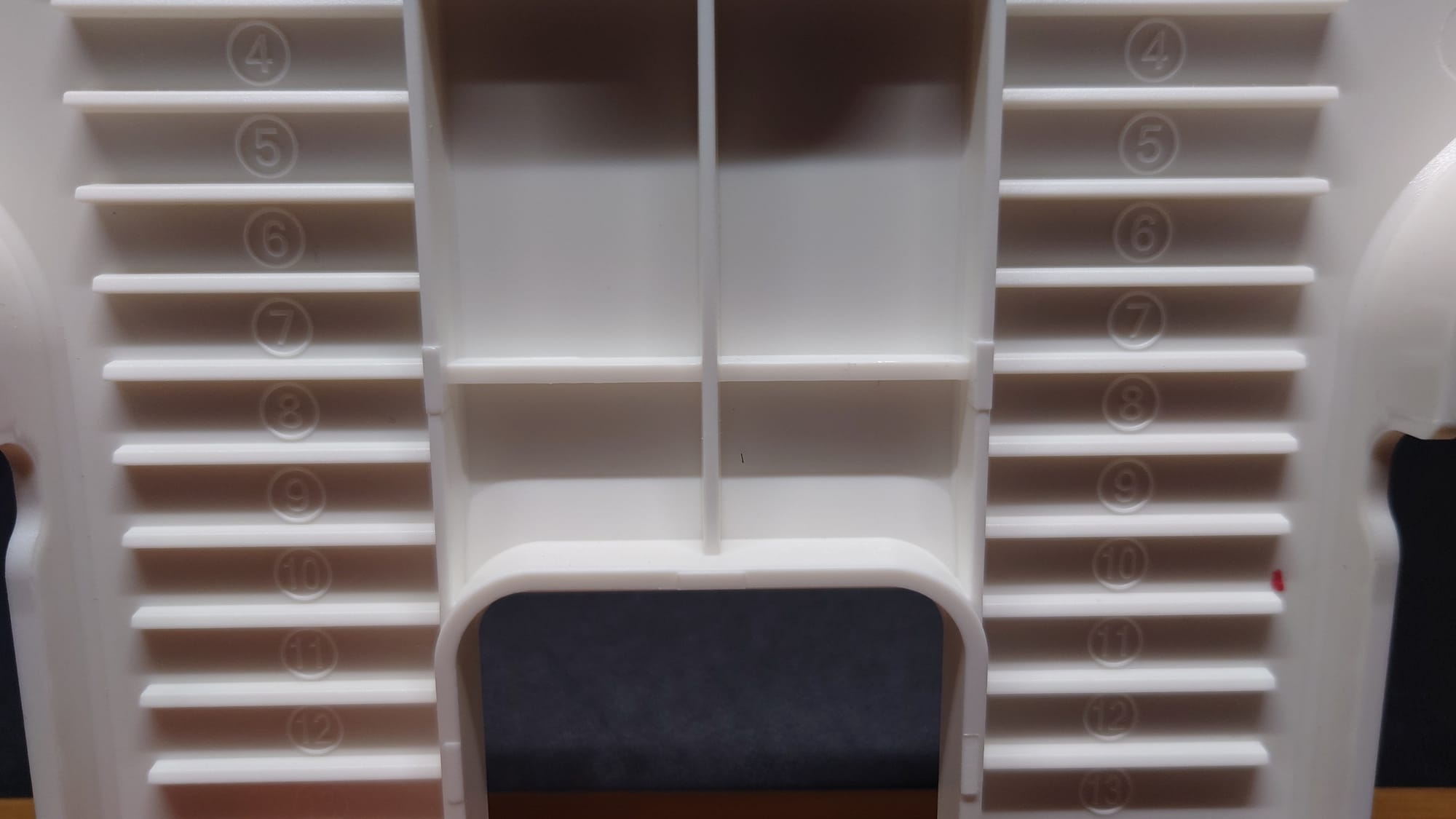 The bottom of the stand has 13 notches for adjusting angle.  The numbers are raised on the plastic in between the grooves.