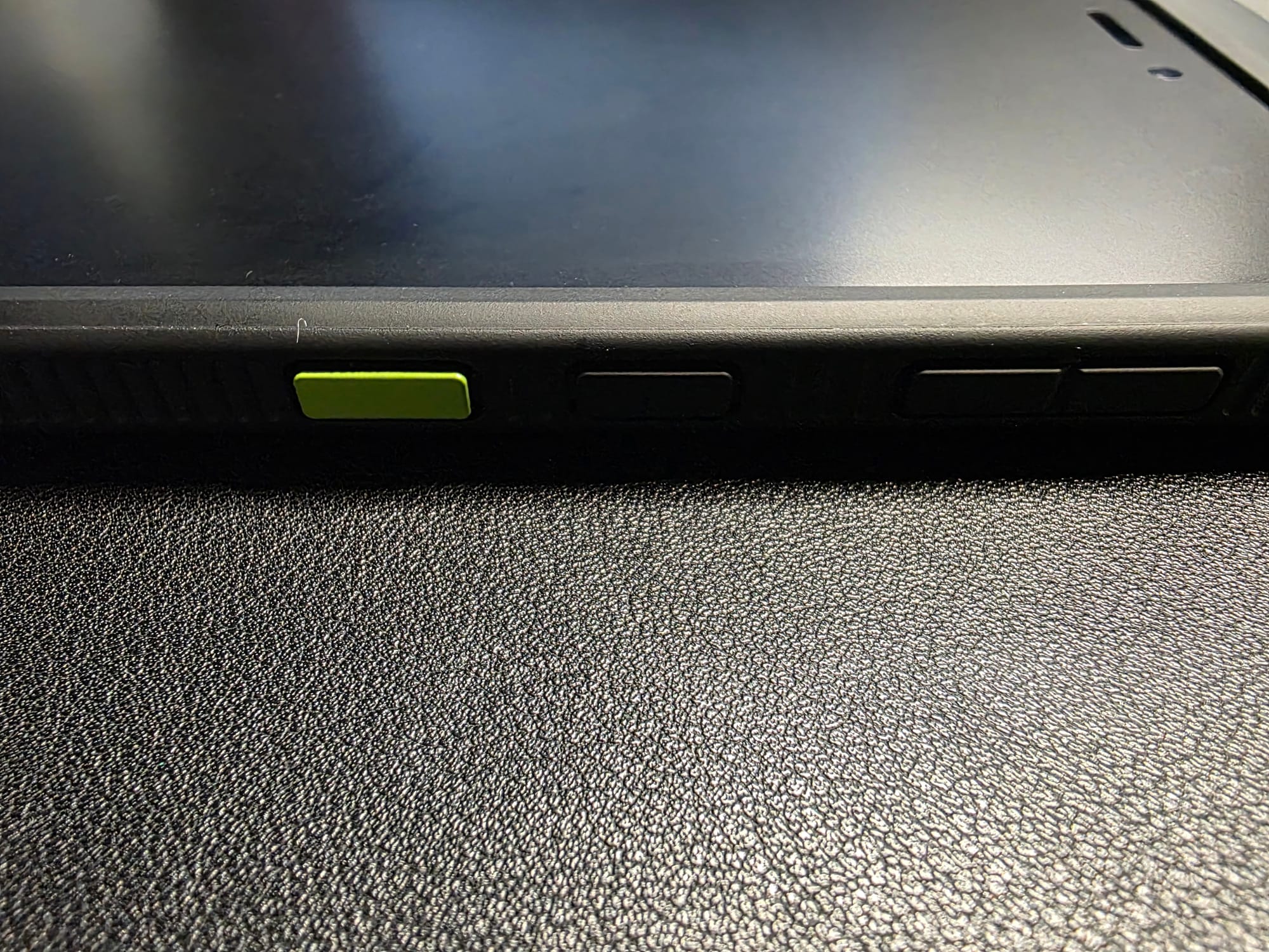 The tablet's array of buttons, including the programmable green action button on the far left with power button next to it and volume up/down buttons at the top