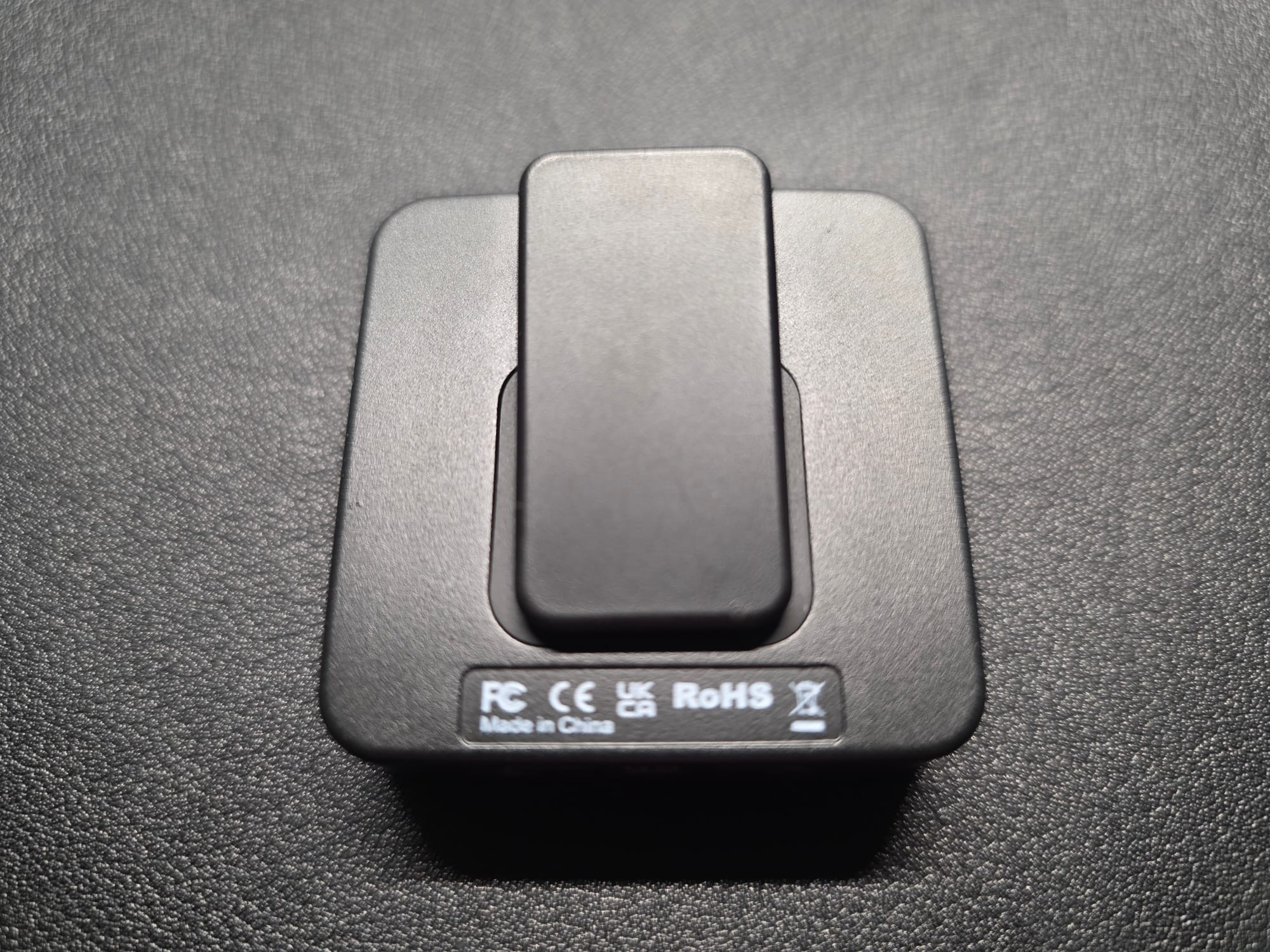 The rear of the Accessport Pro.  It is lying flat on a black desk.